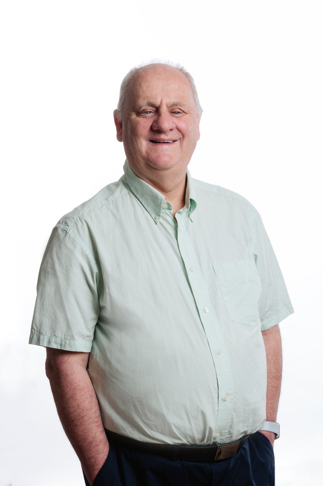 Professional headshot of Neil Jarvis wearing a light green shirt